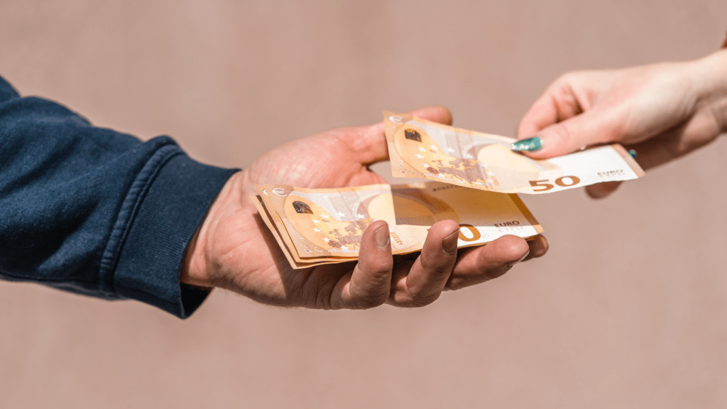 two people exchanging money