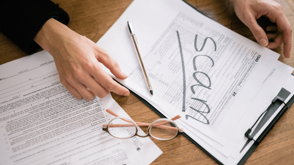 a man looking at a paper with a scam written on it