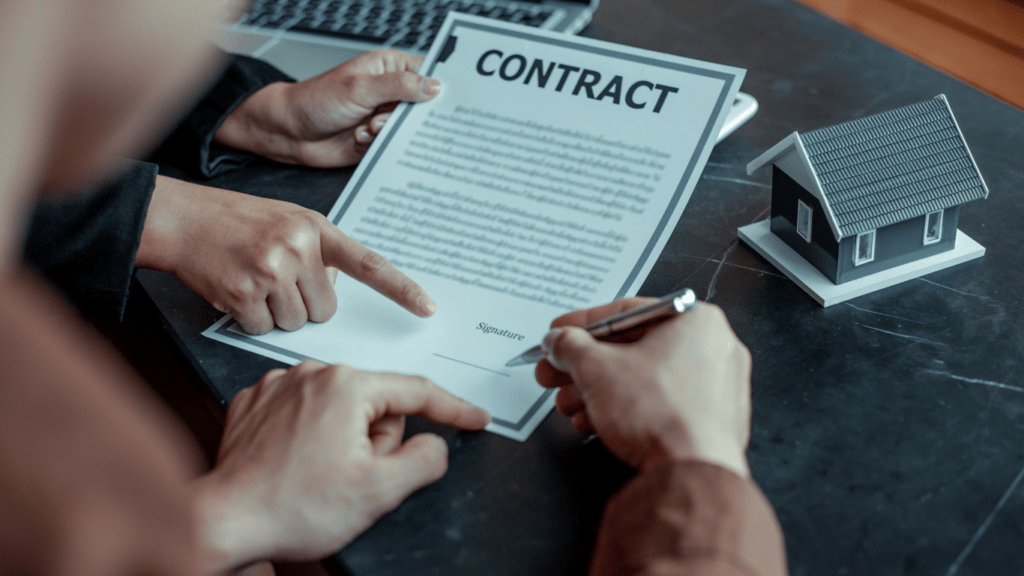 a man signing a contract
