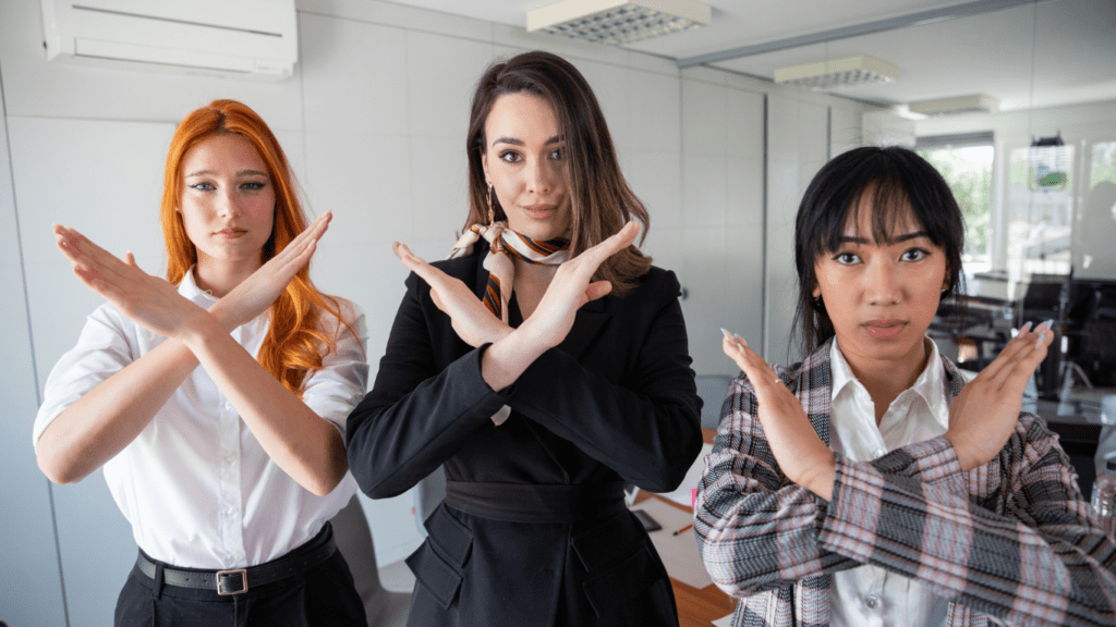 three women giving a no sign 